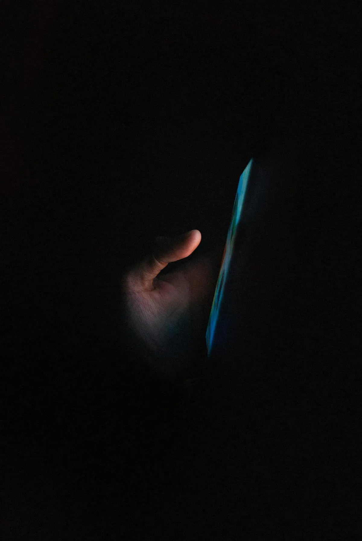 A glowing phone screen in a dark room